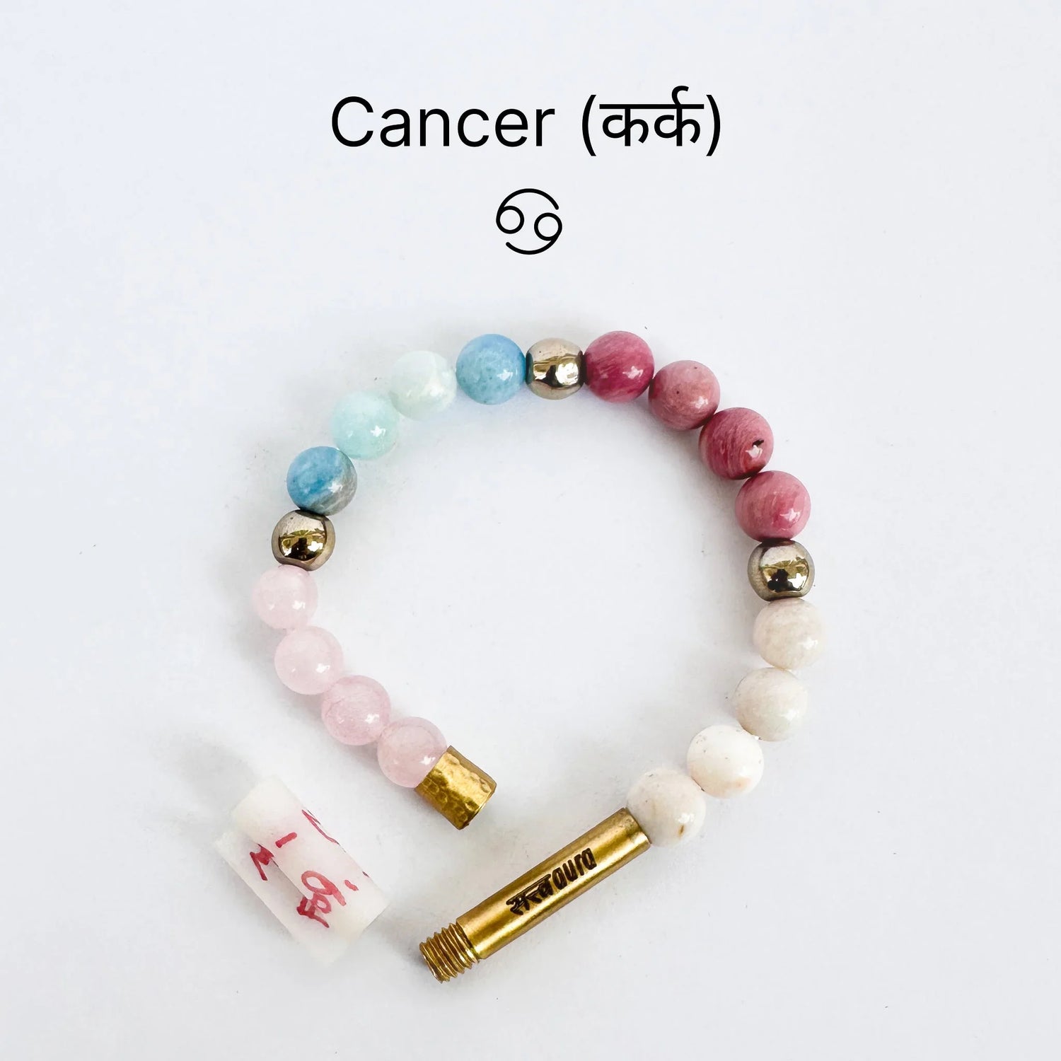 Cancer zodiac sign gemstone bracelet with pastel beads and a brass clasp on white background